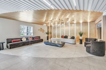 A living room with couches and chairs and a chandelier
